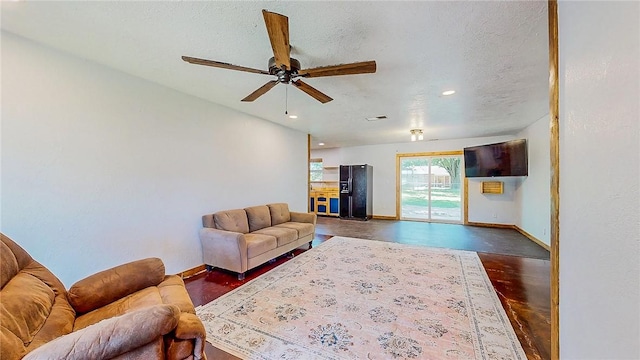 living area with ceiling fan, baseboards, recessed lighting, and finished concrete flooring