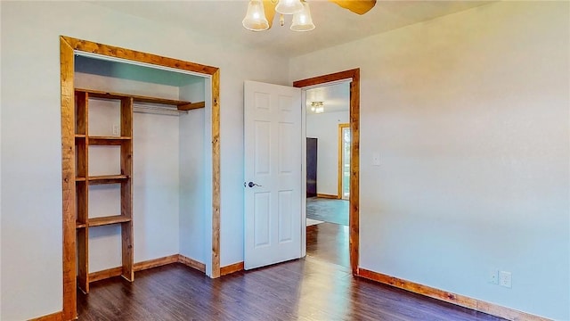 unfurnished bedroom featuring baseboards and dark wood-style flooring