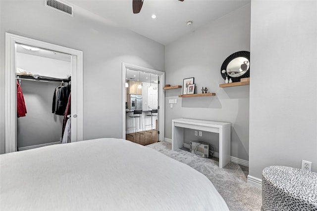 401 W Watson St Unit 408, Fayetteville, AR 72701 - carpeted bedroom with stainless steel fridge with ice dispenser, baseboards, a ceiling fan, a closet, and vaulted ceiling