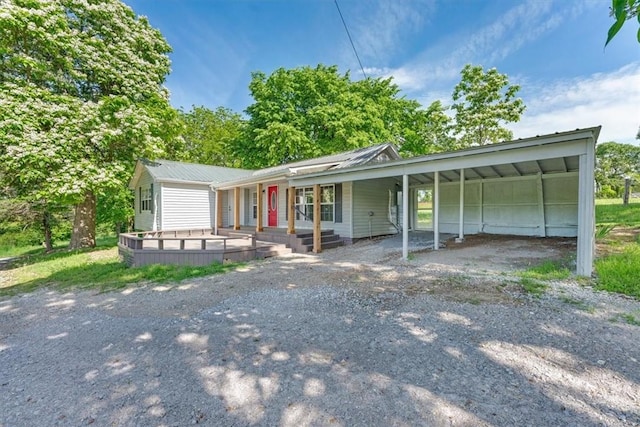 21106 Kirksey Rd, Elkins, AR 72727 - ranch-style home featuring a carport, dirt driveway, covered porch, and metal roof