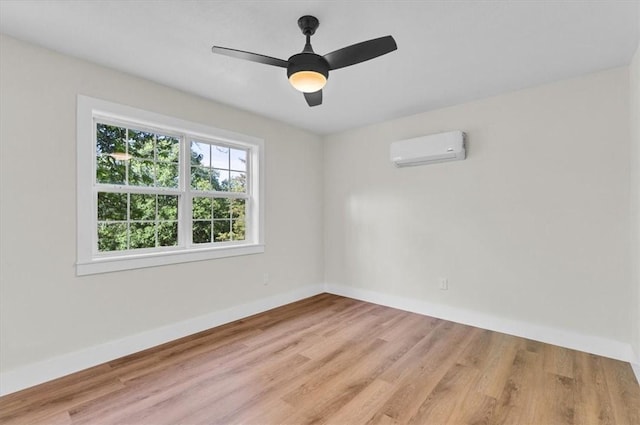 21106 Kirksey Rd, Elkins, AR 72727 - unfurnished room featuring a wall unit AC, baseboards, light wood-style floors, and a ceiling fan