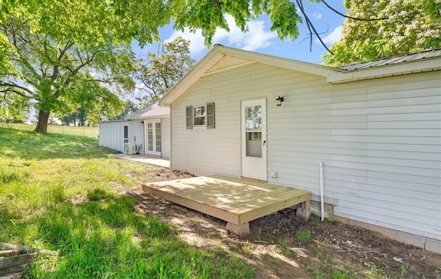 21106 Kirksey Rd, Elkins, AR 72727 - back of property with french doors, metal roof, a yard, and a wooden deck