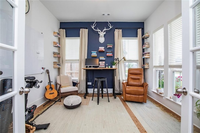living area with wood finished floors and baseboards