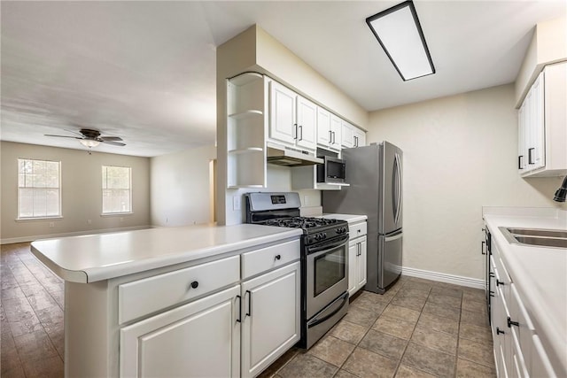 655 Bloomfield St, Gentry, AR 72734 - kitchen featuring stainless steel appliances, under cabinet range hood, baseboards, a peninsula, and white cabinets