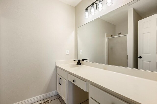 655 Bloomfield St, Gentry, AR 72734 - bathroom featuring baseboards, vanity, a shower stall, and tile patterned flooring
