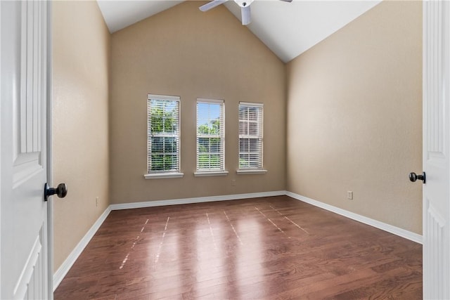 spare room with ceiling fan, wood finished floors, baseboards, and high vaulted ceiling