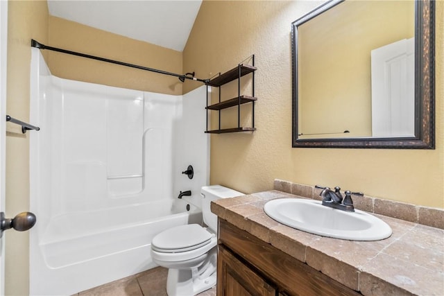 full bathroom with a textured wall, toilet, vaulted ceiling, vanity, and tile patterned flooring