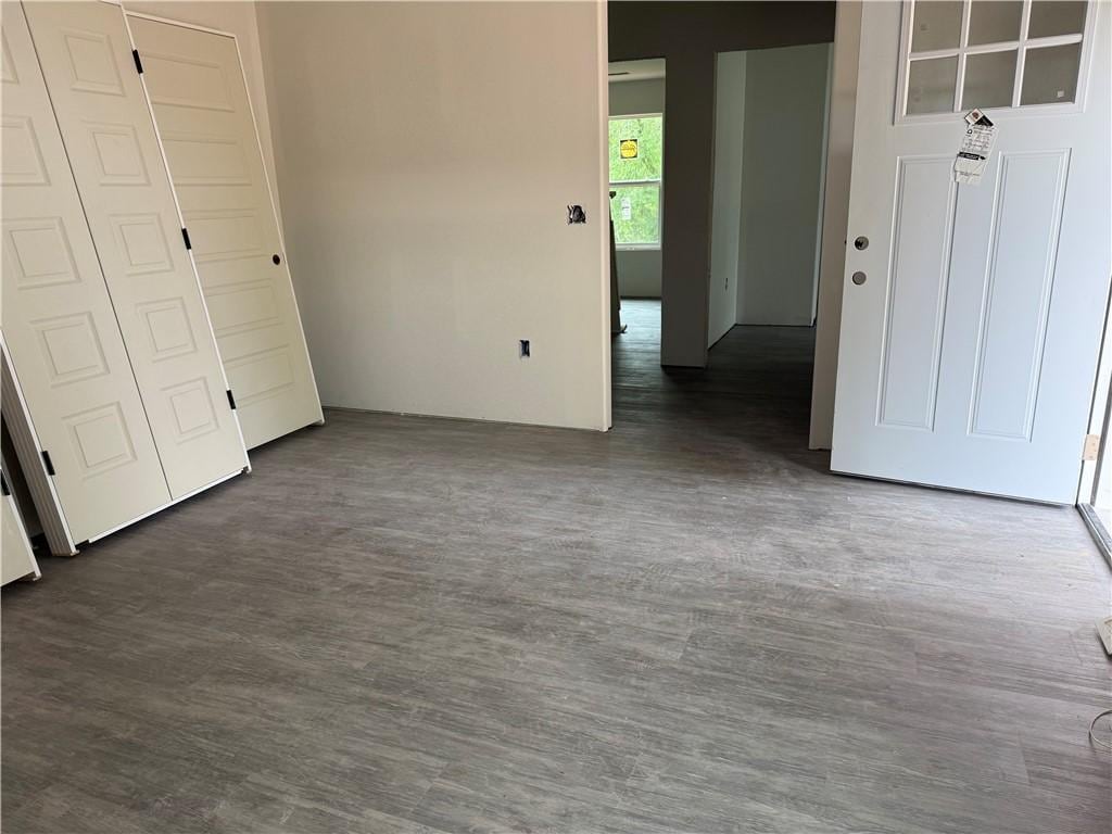 132 Mae, Huntsville, AR 72740 - unfurnished bedroom featuring dark wood-style flooring and a closet