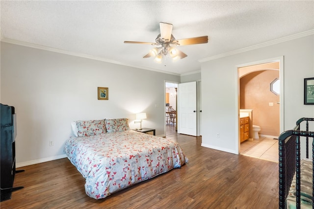 10 Forfar Cir, Bella Vista, AR 72715 - bedroom with arched walkways, wood finished floors, baseboards, ornamental molding, and ensuite bath