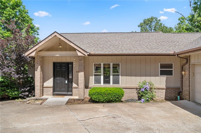 10 Forfar Cir, Bella Vista, AR 72715 - view of front of property featuring brick siding, a shingled roof, an attached garage, and concrete driveway