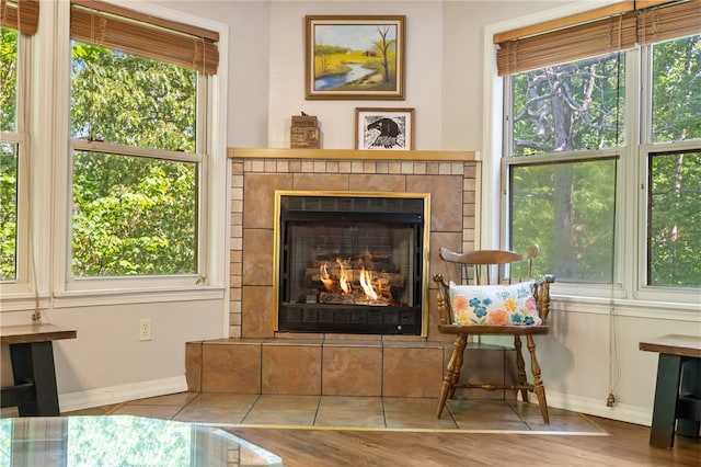 10 Forfar Cir, Bella Vista, AR 72715 - living area with baseboards, healthy amount of natural light, a tile fireplace, and wood finished floors
