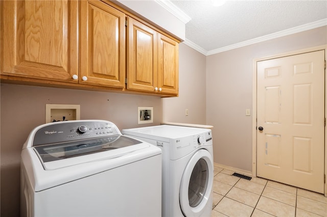 10 Forfar Cir, Bella Vista, AR 72715 - clothes washing area featuring washer and clothes dryer, cabinet space, light tile patterned floors, ornamental molding, and a textured ceiling