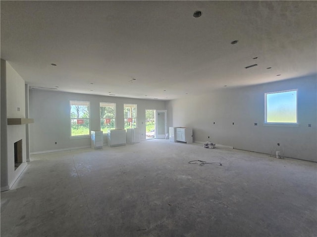 2308 Lexington St, Siloam Springs, AR 72761 - unfurnished living room featuring plenty of natural light, a fireplace, and baseboards