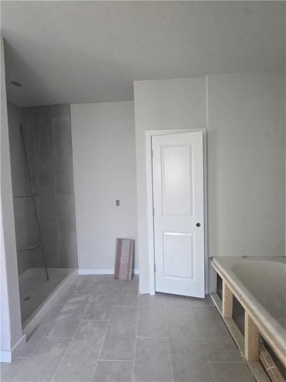 2308 Lexington St, Siloam Springs, AR 72761 - full bathroom featuring a bath, tile patterned flooring, baseboards, and a tile shower