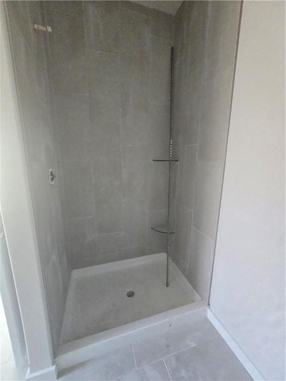 2308 Lexington St, Siloam Springs, AR 72761 - bathroom with a tile shower, tile patterned flooring, and baseboards