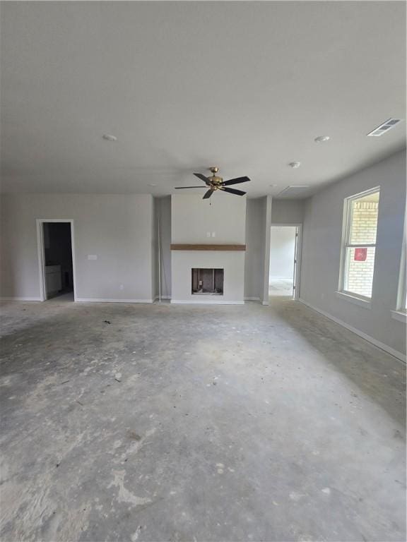 2308 Lexington St, Siloam Springs, AR 72761 - unfurnished living room featuring a ceiling fan, a fireplace, and concrete floors