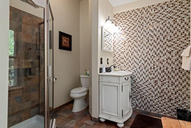 35 Kingshighway, Eureka Springs, AR 72632 - bathroom featuring a stall shower, vanity, toilet, and stone finish flooring