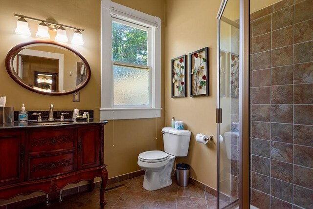 35 Kingshighway, Eureka Springs, AR 72632 - full bathroom with a stall shower, baseboards, toilet, and vanity