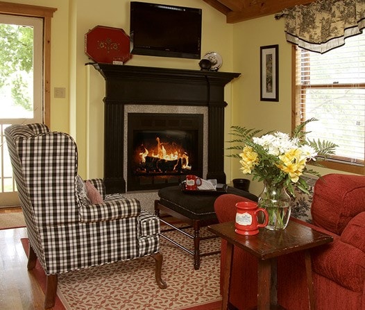 35 Kingshighway, Eureka Springs, AR 72632 - sitting room with wood finished floors, a lit fireplace, and beamed ceiling