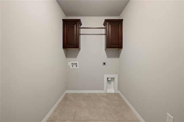 4471 W Oldham Dr, Fayetteville, AR 72704 - washroom featuring electric dryer hookup, washer hookup, cabinet space, light tile patterned flooring, and baseboards