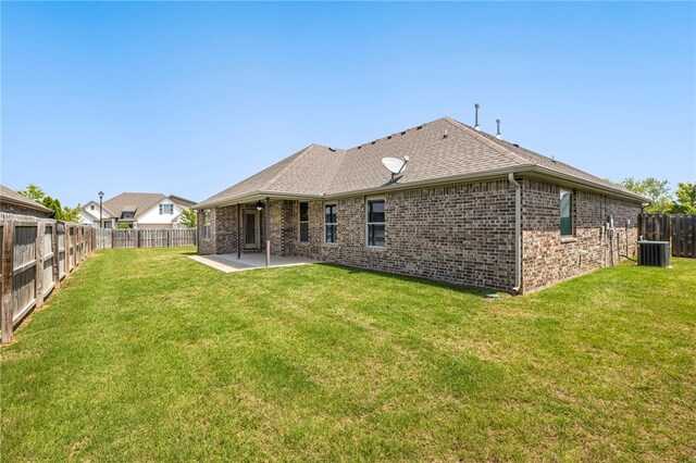 4471 W Oldham Dr, Fayetteville, AR 72704 - back of property featuring central AC unit, a patio, brick siding, and roof with shingles