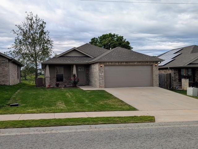 508 NW 62nd Ave, Bentonville, AR 72713 - view of front facade featuring an attached garage, concrete driveway, brick siding, and roof with shingles