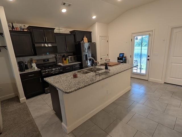 508 NW 62nd Ave, Bentonville, AR 72713 - kitchen with stainless steel appliances, a sink, a center island with sink, lofted ceiling, and light stone counters