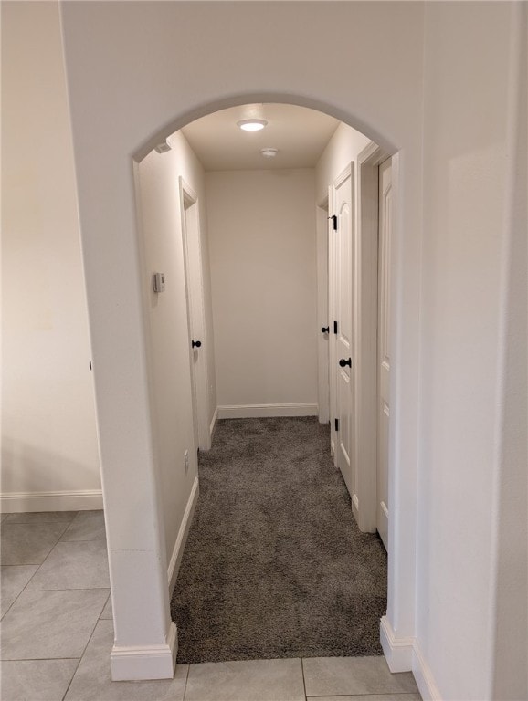 508 NW 62nd Ave, Bentonville, AR 72713 - hall featuring arched walkways, baseboards, and light tile patterned floors