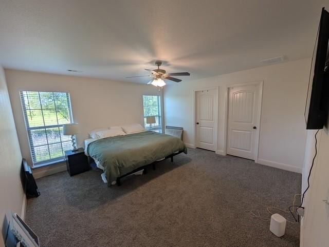 508 NW 62nd Ave, Bentonville, AR 72713 - carpeted bedroom with ceiling fan, baseboards, and multiple closets