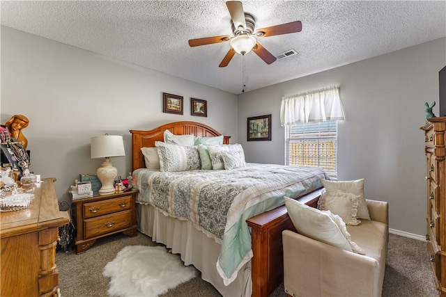bedroom featuring carpet flooring, a textured ceiling, ceiling fan, and baseboards