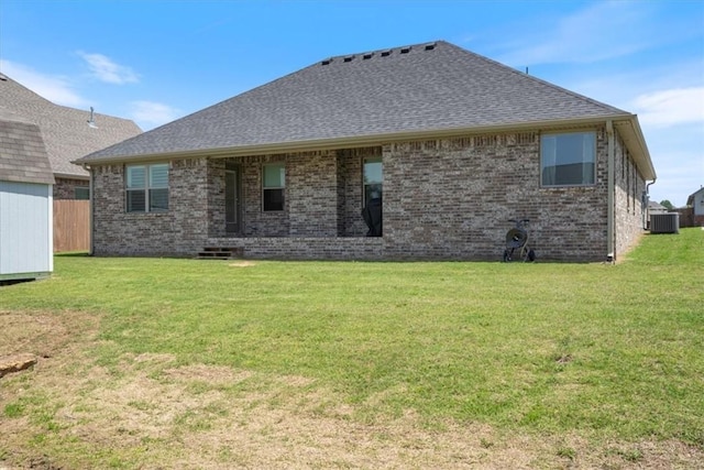 2204 N Kathryn Ln, Siloam Springs, AR 72761 - rear view of property featuring a yard, central air condition unit, brick siding, and a shingled roof