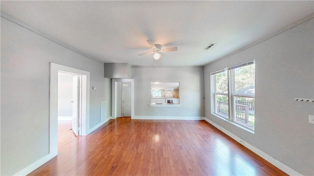 1230 W Mount Comfort Rd, Fayetteville, AR 72703 - unfurnished living room featuring ceiling fan, wood finished floors, and baseboards