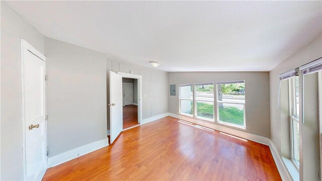 1230 W Mount Comfort Rd, Fayetteville, AR 72703 - unfurnished room featuring light wood finished floors, baseboards, and electric panel