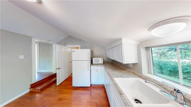 1230 W Mount Comfort Rd, Fayetteville, AR 72703 - kitchen with white appliances, a sink, wood finished floors, white cabinetry, and vaulted ceiling