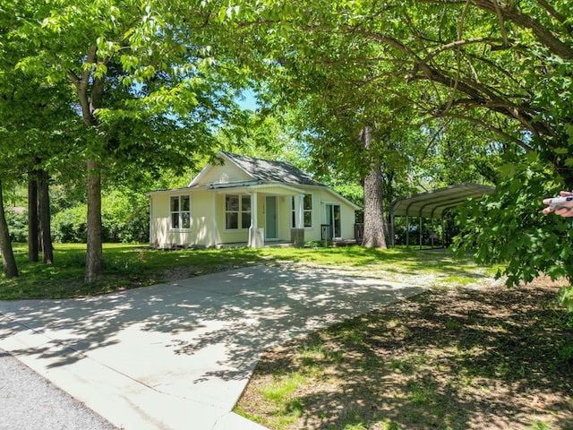 1230 W Mount Comfort Rd, Fayetteville, AR 72703 - view of front facade with driveway, a carport, and a front lawn