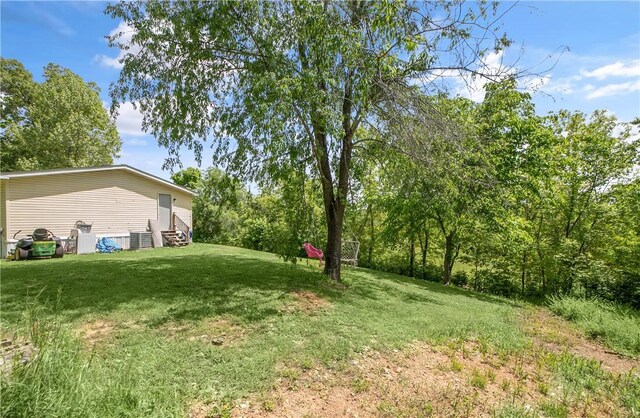 14650 Mariano Rd, Bentonville, AR 72712 - view of green lawn featuring entry steps and central air condition unit