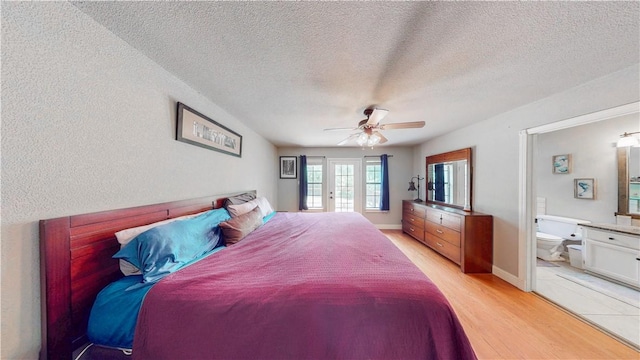 12526 Avoca Hollow Rd, Garfield, AR 72732 - bedroom with light wood finished floors, a textured ceiling, connected bathroom, and ceiling fan