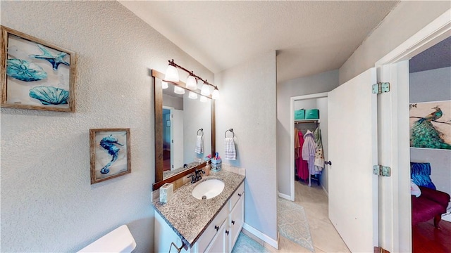 12526 Avoca Hollow Rd, Garfield, AR 72732 - bathroom featuring vanity, a textured wall, and toilet