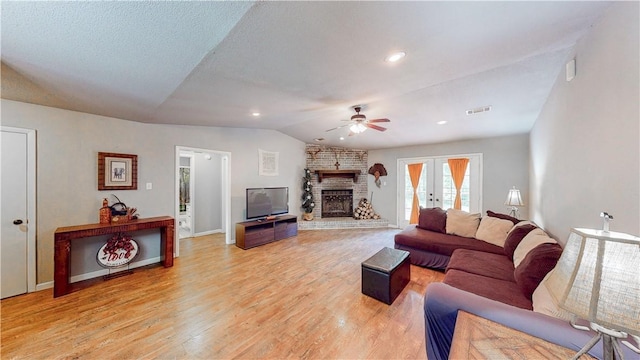 12526 Avoca Hollow Rd, Garfield, AR 72732 - living area featuring a ceiling fan, a brick fireplace, lofted ceiling, light wood-style flooring, and baseboards