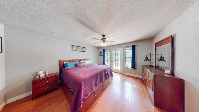 12526 Avoca Hollow Rd, Garfield, AR 72732 - bedroom with access to outside, baseboards, light wood finished floors, a textured ceiling, and a ceiling fan