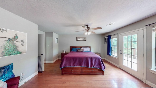 12526 Avoca Hollow Rd, Garfield, AR 72732 - bedroom with light wood finished floors, access to outside, a textured ceiling, baseboards, and a ceiling fan