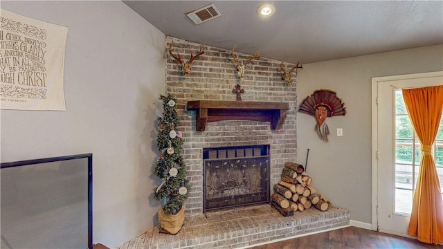 12526 Avoca Hollow Rd, Garfield, AR 72732 - living area with wood finished floors, a fireplace, and baseboards