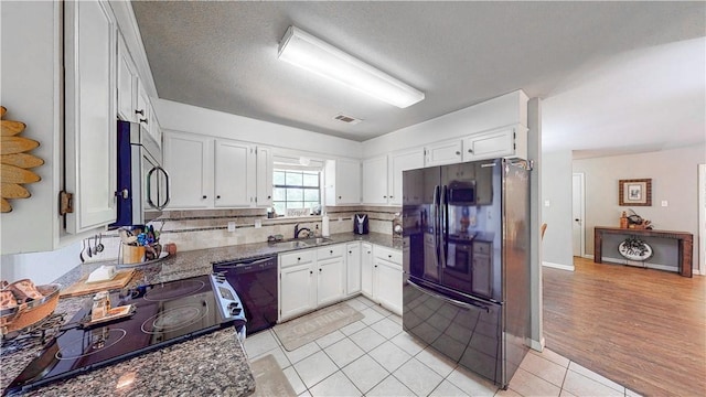 12526 Avoca Hollow Rd, Garfield, AR 72732 - kitchen with black appliances, a sink, dark stone countertops, white cabinetry, and a textured ceiling