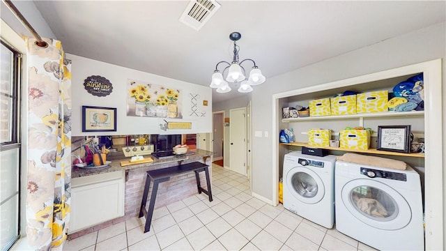 12526 Avoca Hollow Rd, Garfield, AR 72732 - washroom featuring washing machine and clothes dryer, a chandelier, and light tile patterned floors