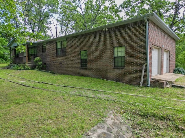 12526 Avoca Hollow Rd, Garfield, AR 72732 - view of home's exterior featuring brick siding, a yard, and a garage