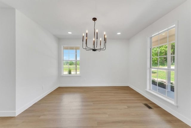 12391 Shamrock Rd, Farmington, AR 72730 - spare room featuring a chandelier, light wood-style floors, baseboards, and recessed lighting