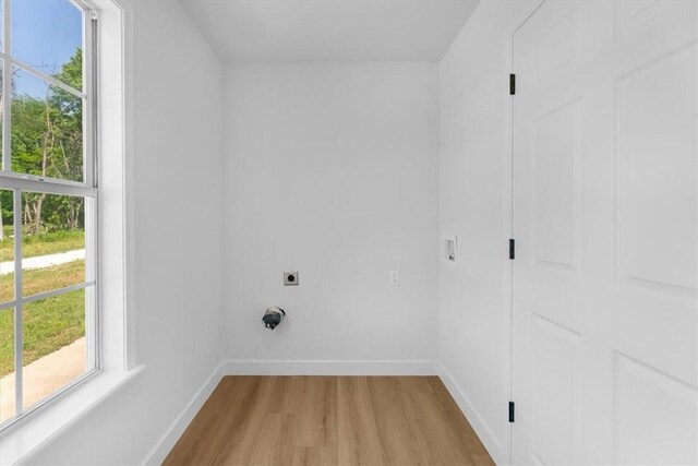 12391 Shamrock Rd, Farmington, AR 72730 - laundry area featuring electric dryer hookup, light wood-type flooring, baseboards, and plenty of natural light