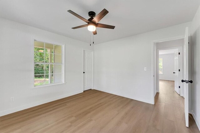 12391 Shamrock Rd, Farmington, AR 72730 - spare room with light wood finished floors, a ceiling fan, healthy amount of natural light, and baseboards