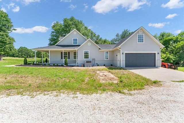 12391 Shamrock Rd, Farmington, AR 72730 - view of front of house with concrete driveway, a garage, and a front yard
