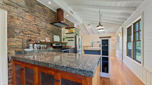 kitchen featuring stainless steel appliances, open shelves, light wood finished floors, island exhaust hood, and a peninsula